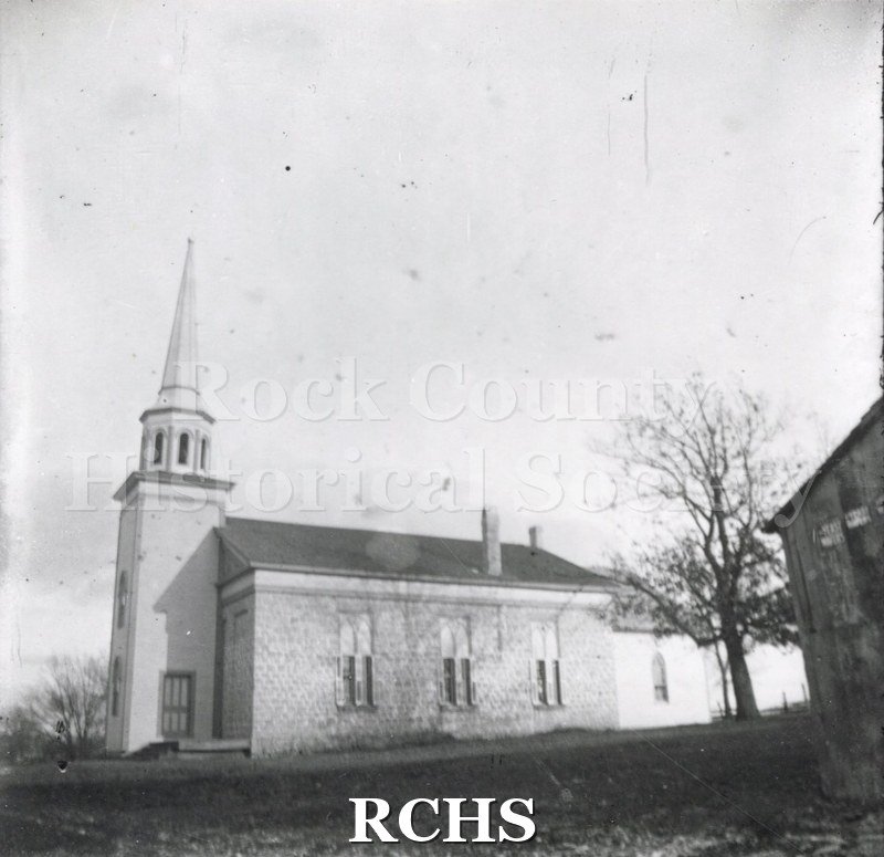 Historic image of Black and white copy print of Shopiere Congregational Church, a one story church with a bell tower on the left.