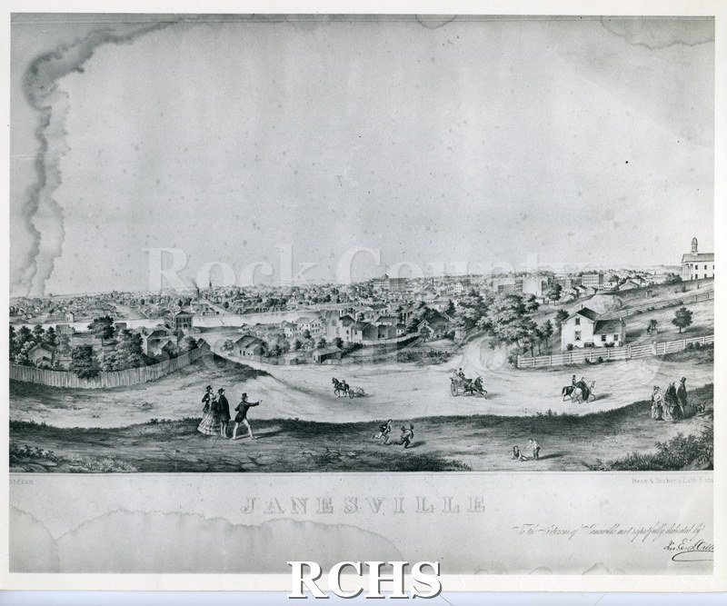 Black and white aerial view of early Janesville. Shows people in foreground, horses and buggies in the middle and houses in the background.