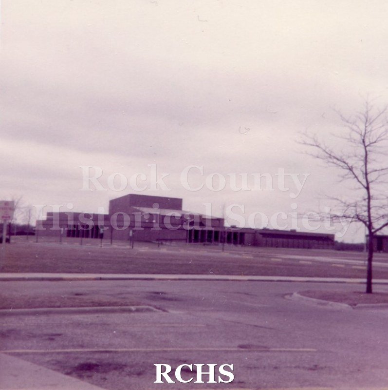 Pinkish photograph of U.W. Rock Center Auditorium. Transcription.