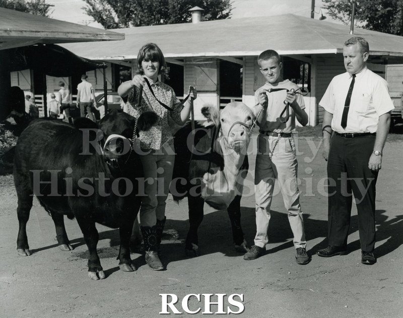Black and white photograph of Nancy Reid and steer; Steven Seichter and steer and Darold Drew.