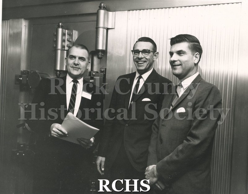 Black and white photograph of Alan Dunwiddie, Harold Deyer and Robert Ruth standing near a curtain.