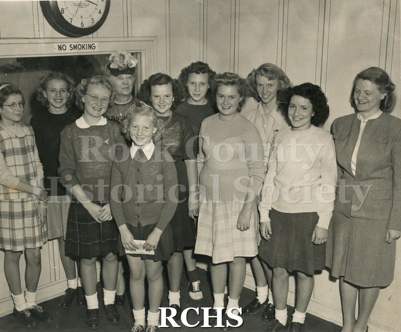 Black and white photograph of the Silver Springs Singing Group of Cooksville School. Shows nine young girls and two women standing in a room.