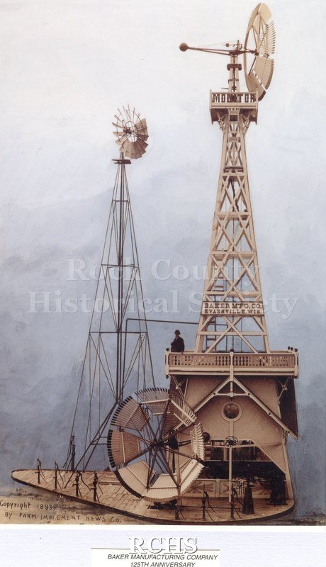 Color photo of Baker Manufacturing Company windmills with a man standing on the platform.