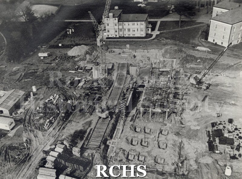 Black and white copy print aerial view of the grounds of the Rock County Mental Hospital. Shows the construction of the Health Care Center.