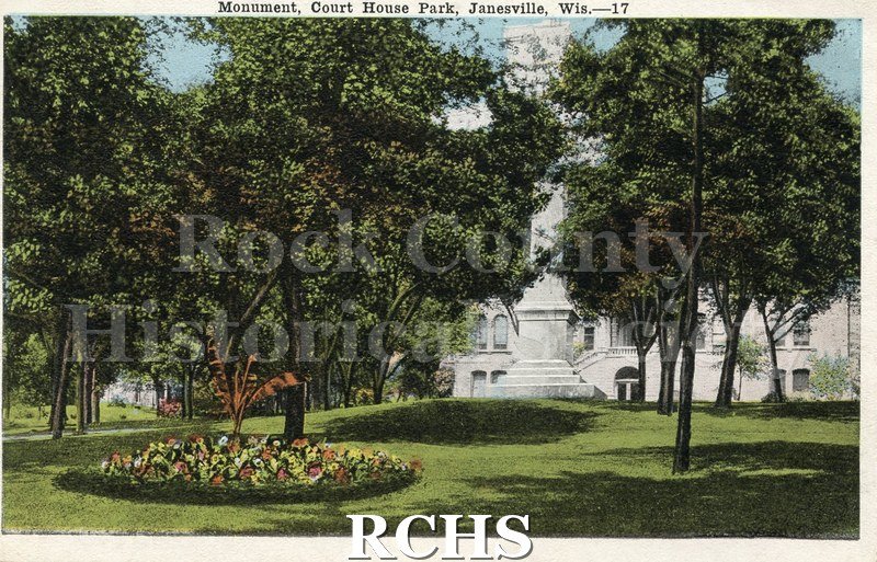 Historic image of White stock paper post card. Color drawing of "Monument, Court House Park, Janesville, Wis.-17". Letter side. Hand text with black ink.