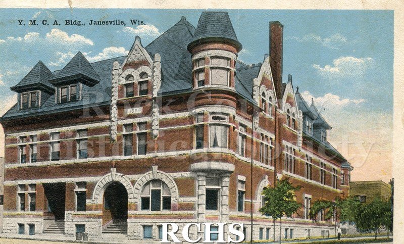 Postcard of Y.M.C.A Building. Red brick. A few people visible in foreground. On reverse is written "Marjorie/ from/ Arch Richards" in black ink.