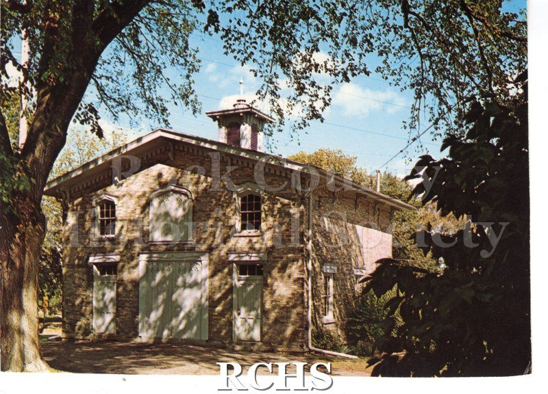 Historic image of Post Card of Tallman Carriage House. Tree on left, leaves up close on right. Handwritten note in green ink on reverse.