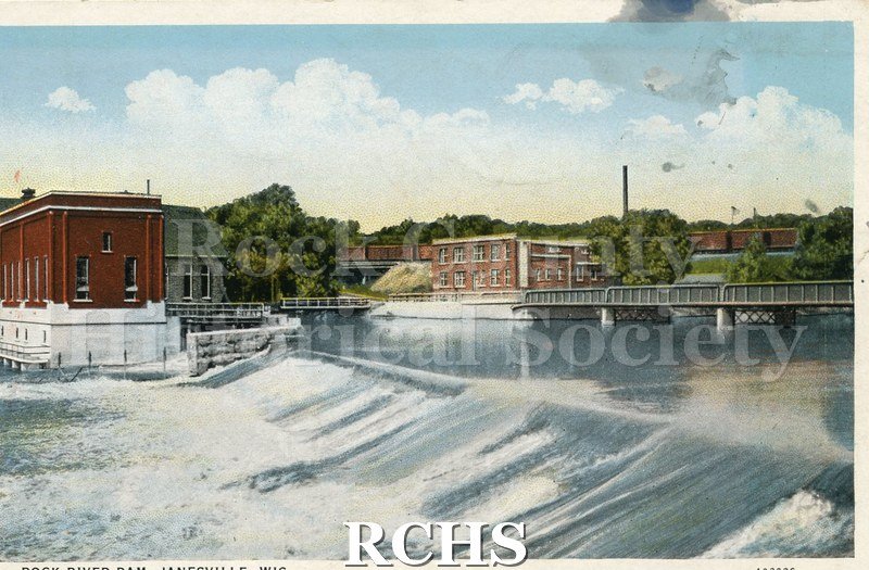 Postcard. Tinted image of the dam on the Rock River with electric company building at edge. Postmarked 28 January 1930 and addressed to Mr. and Mrs.