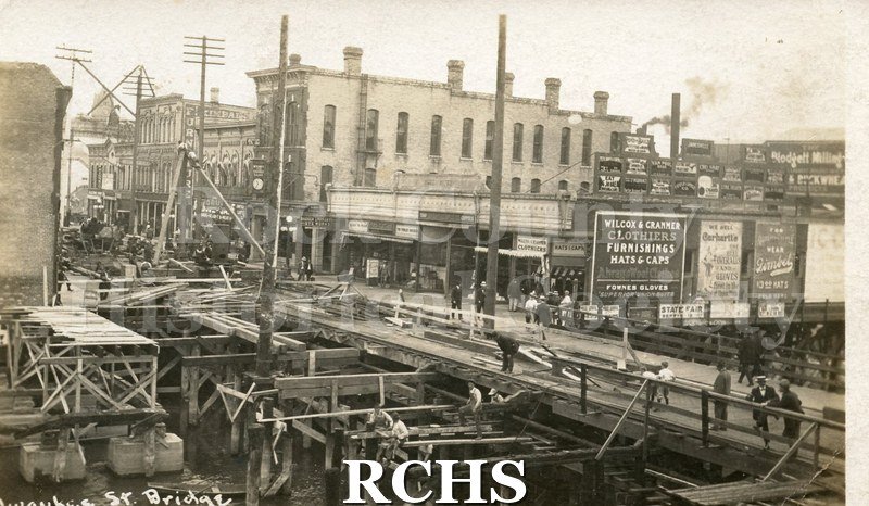 Postcard. Black and white photograph of the Milwaukee Street bridge being rebuilt after the April 1913 fire.