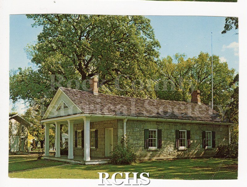 Historic image of Post Card of Stone House. Trees in background Handwritten note in green ink on reverse. Reverse has no writing, postmark or stamp.
