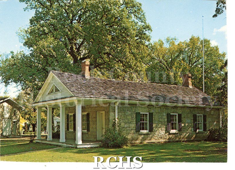 Historic image of Post Card of Stone House. Trees in background Handwritten note in green ink on reverse. Handwritten note in green ink on reverse.