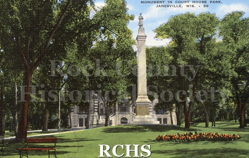Historic image of Monument in Court House Park/Janesville, Wis - 56". Tall white stone monument with soldier on top.