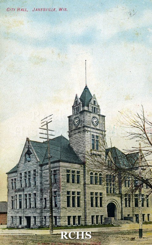 Postcard. Tinted image of the exterior of City Hall in Janesville. Postmarked 25 August 1910 and addressed to Clara Brigham of Hebron, Illinois.