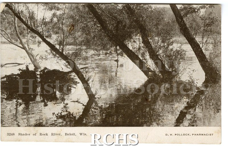 Small postcard. Front has black and white picture of a a shallow part of the Rock River with trees growing up out of the water.