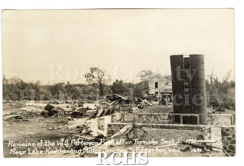 3-1/2" x 5-1/2" glossy picture postcard showing farm after tornado. Farmhouse seems to be intact. On bottom: "Remains of the W. J. Patterson Farm after Tornado Sept.