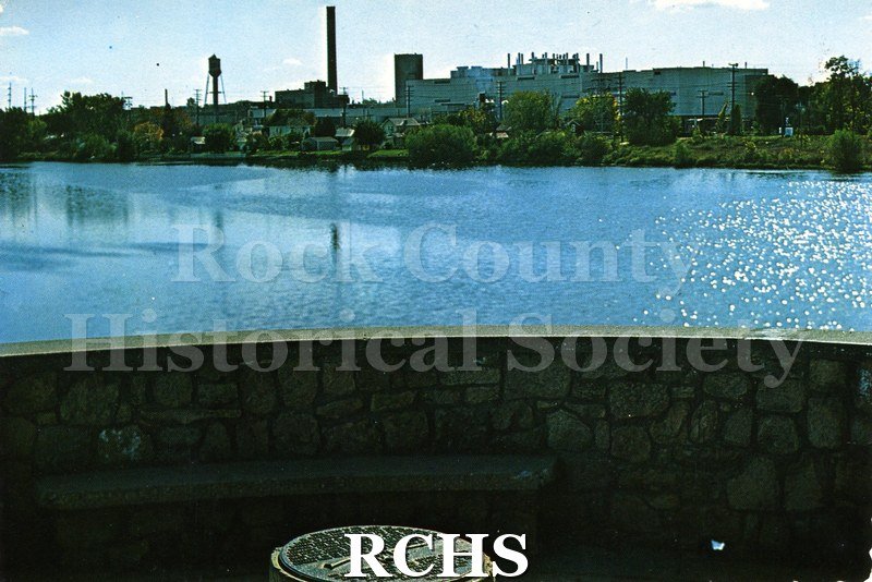 Postcard. color photo of the General Motors plant in Janesville from across the Rock River.