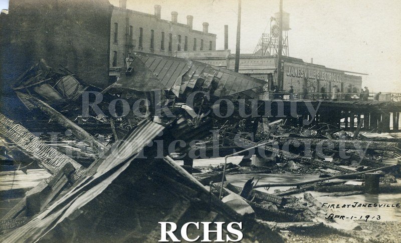 Postcard. Black and white photograph of the wreckage after the April 1913 Milwaukee Street fire. Postmarked 19 May 1913 and addressed to F.C.