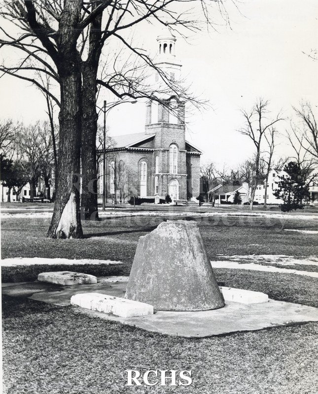 Historic image of First Congregational Church. Shows a large portion of a cannon in the foreground.