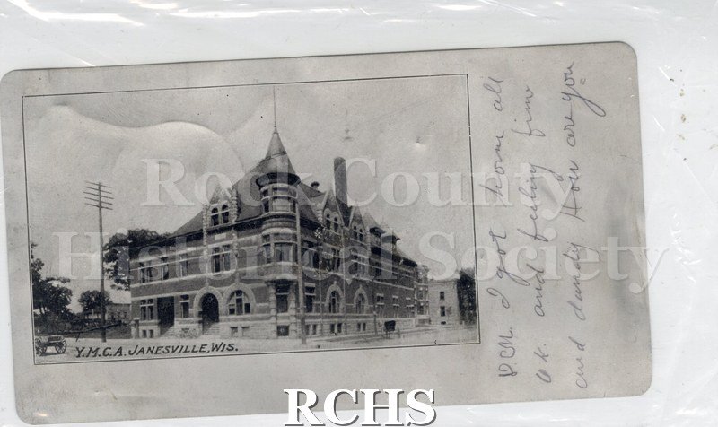 Postcard. Rare aluminum postcard featuring a Black and white photograph of the Y.M.C.A. in Janesville. Message written on front right border in pencil: "D.M.