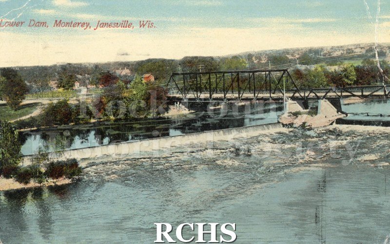 Postcard. Tinted image of the lower dam on the Rock River in Janesville. Postmarked 22 July 1912 and addressed to Alice Barton of Albany, Wisconsin.