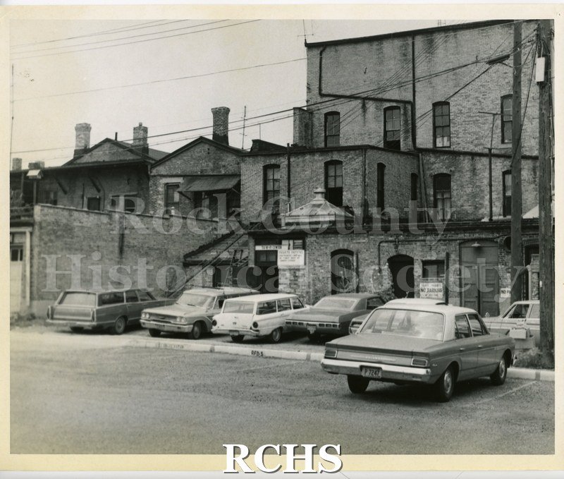 Black and white photograph of the backs of several buildings on North Main..