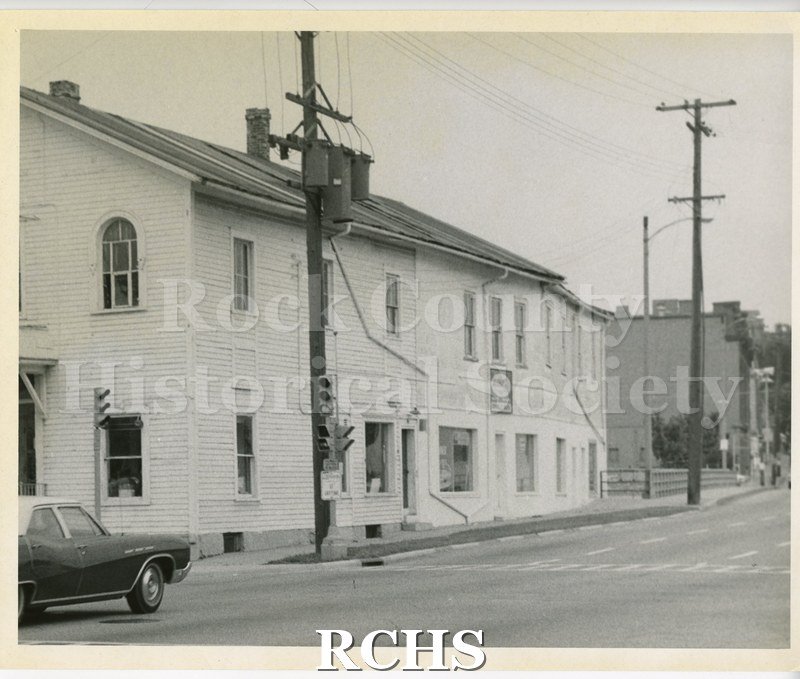 Black and white photograph of Connell's Marine, 16 W. Court. Shows the side of a two story building with sign: "Aluma Craft Boats Canoes Connell's Marine" .