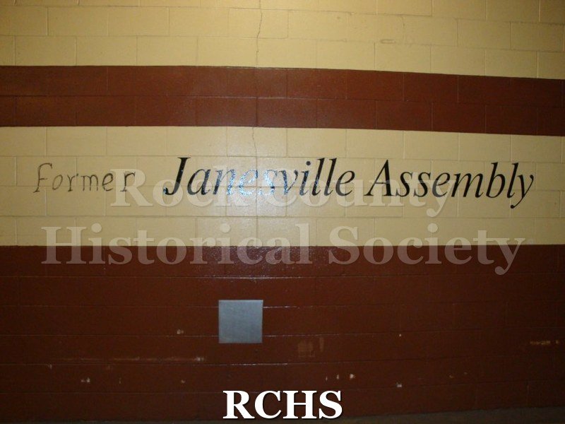 Digital Photograph- Picture of wall in maintenance building stating "former Janesville Assembly." The word "former" added on with marker.