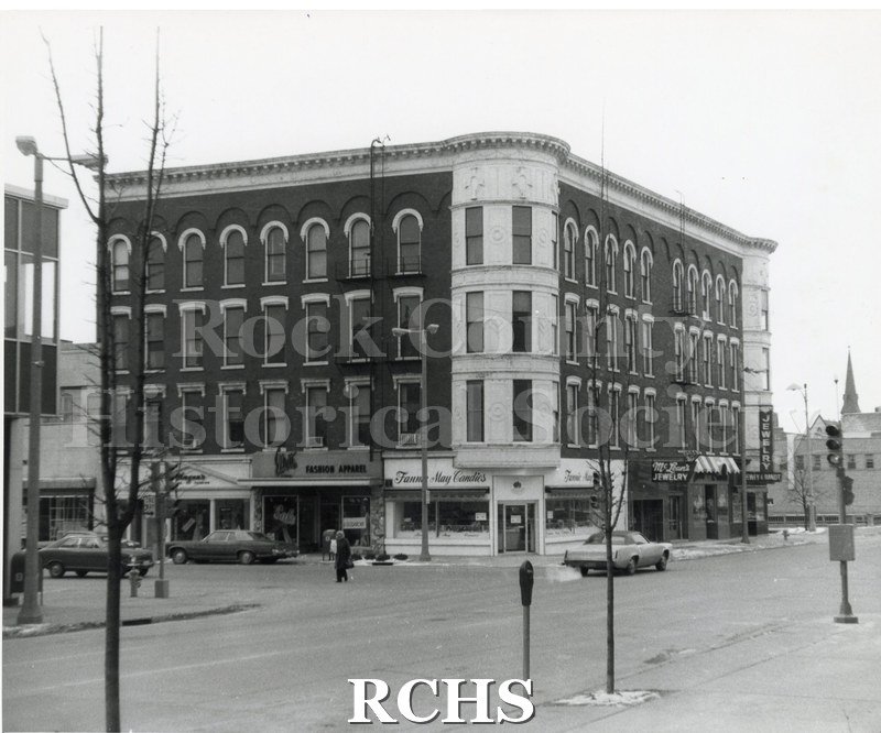 Historic image of Hayes Block. Shows a four story building on a corner.