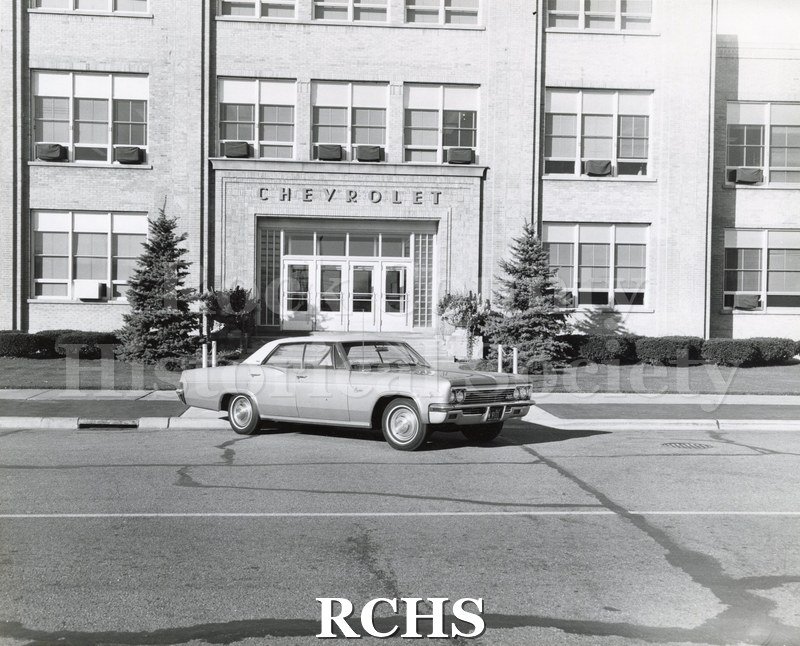 Black and white photograph of Chevrolet outside Janesville GM plant.