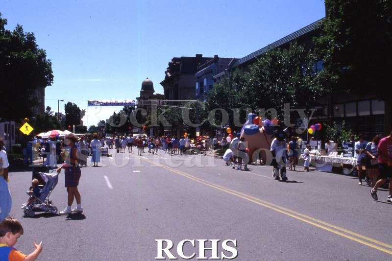 Color photo of people at a Celebrate Janesville street fair.